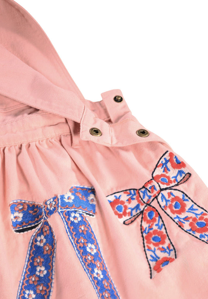 Pink dress with floral bows on a white background