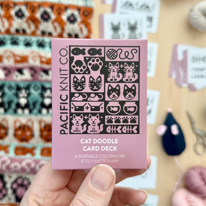 Hand holding the pink Cat Doodle Card Deck by Pacific Knit Co tuckbox