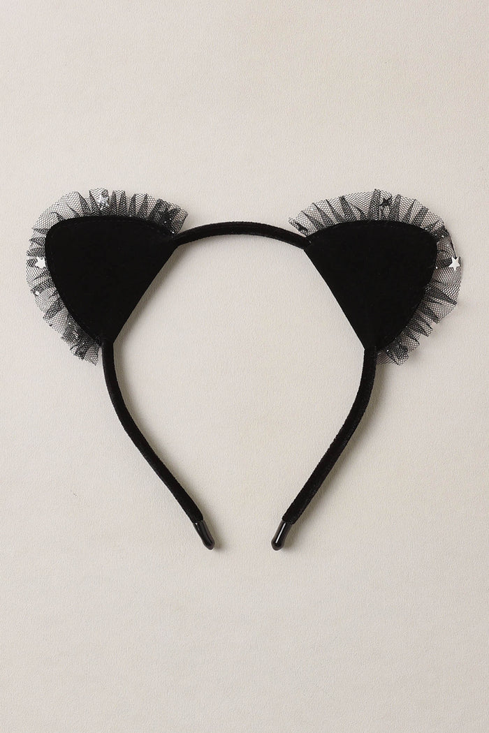 Black cat ear headband with tulle on a beige background
