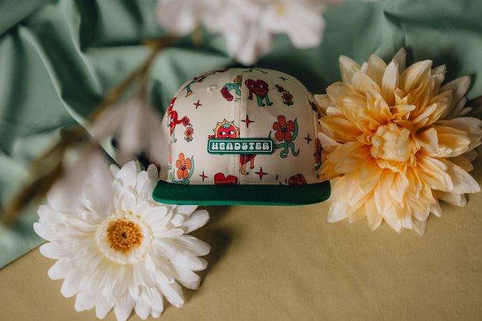 Cap with colorful design on a surface with flowers