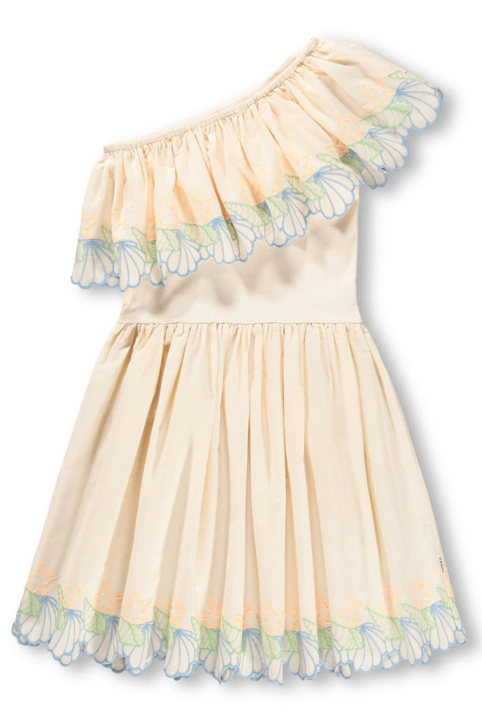 Beige dress with seashell details on a white background
