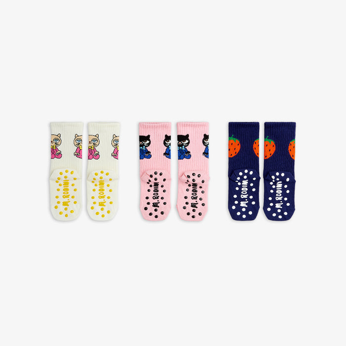 3 pairs of children's socks with various designs on a white background