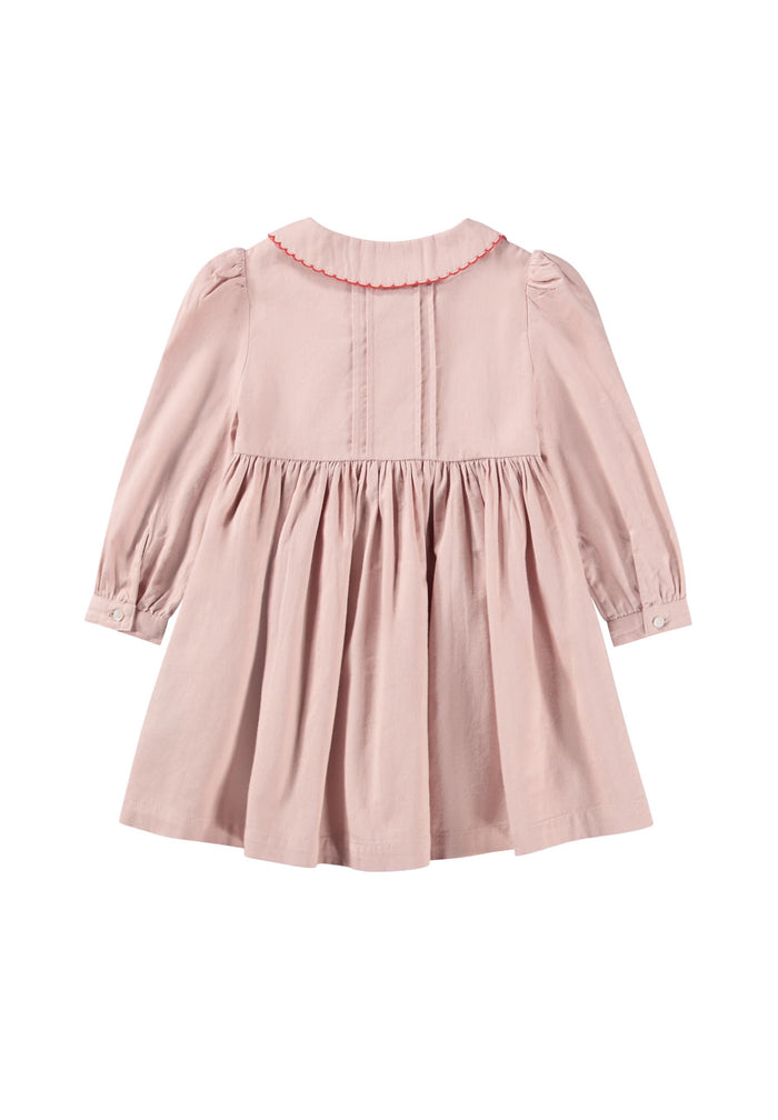 Pink dress with a red trim on a white background