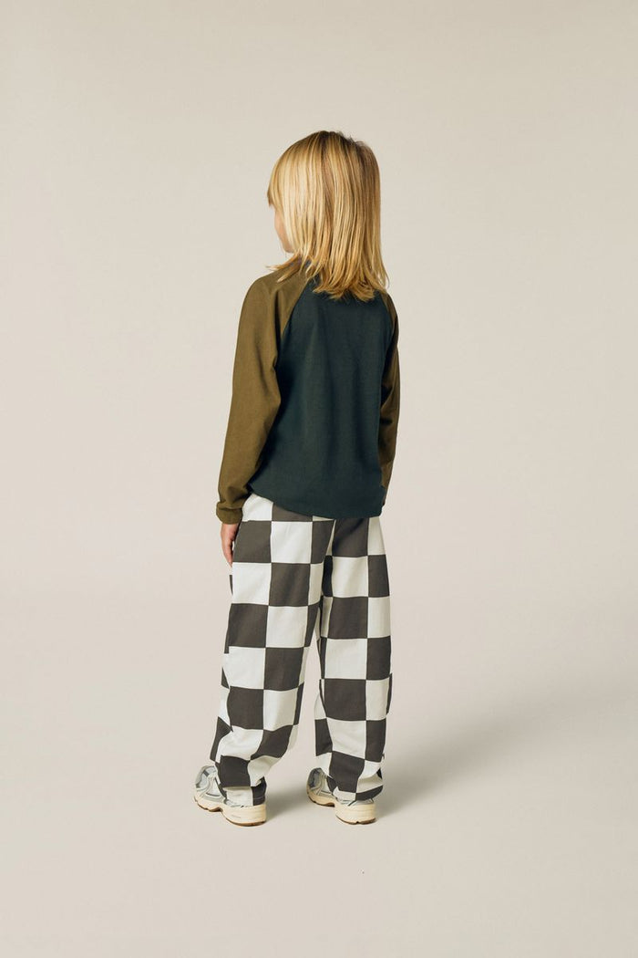 Child wearing checkered trousers