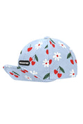 Light blue cap with cherry and flower pattern on a white background