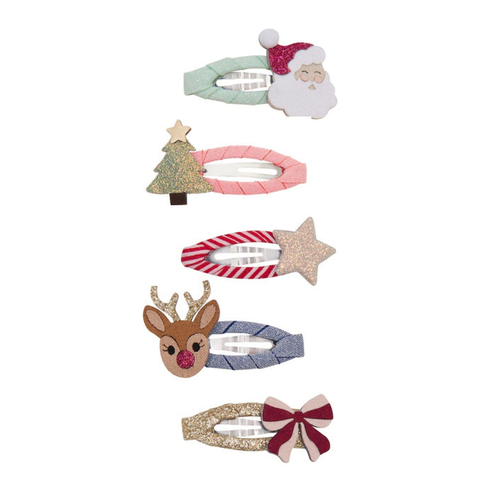 A set of five Christmas-themed hair clips arranged vertically on a plain white background. The clips feature festive designs including a Santa Claus head, a glittery Christmas tree, a red-and-white striped candy cane with a glittery star, a reindeer head, and a red-and-white bow.