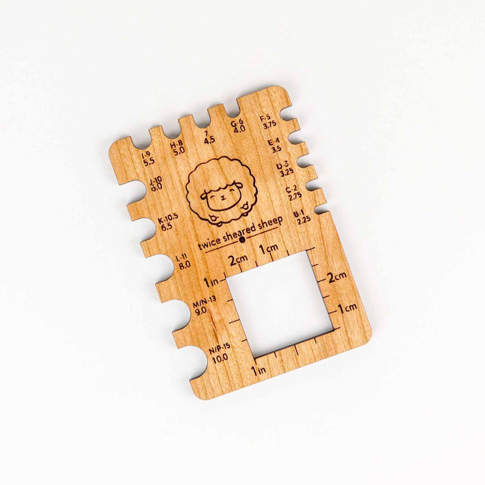 Twice Sheared Sheep wooden crochet hook gauge square with notched slots for sizes B through N/P and inch/cm ruler