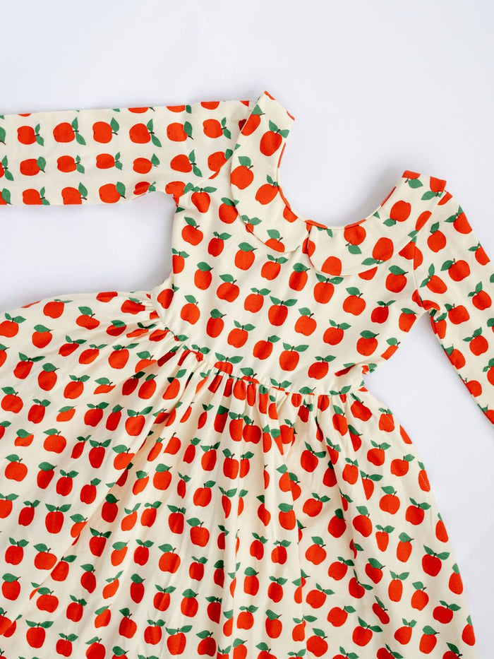 Dress with red apple pattern on a white background