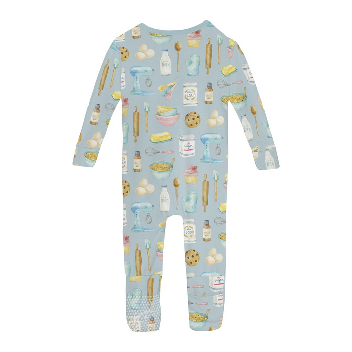 back view of babyromper with multi color baking themed print all over on white background.