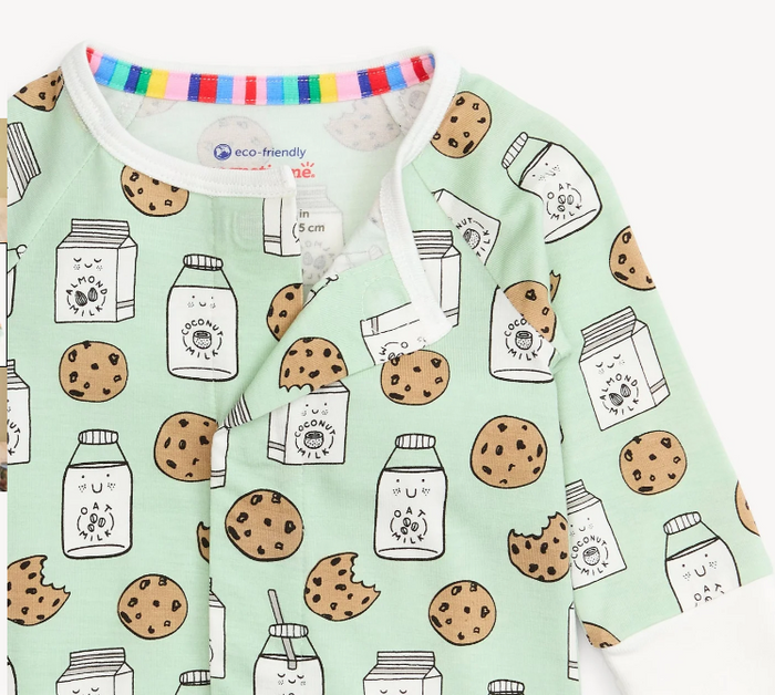 A close-up of a baby long-sleeve sleep sack or top in mint green, featuring a playful print of milk cartons, jars, cookies, and cookie bites. The garment has a white collar and cuffs, a snap-button front closure, and a colorful striped inner neck trim.