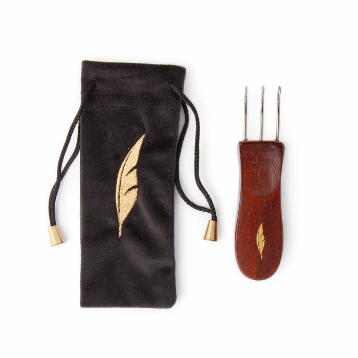 Cord Quill I-cord tool with mango wood handle and gold feather inlay beside a black velvet drawstring storage pouch with embroidered gold feather design