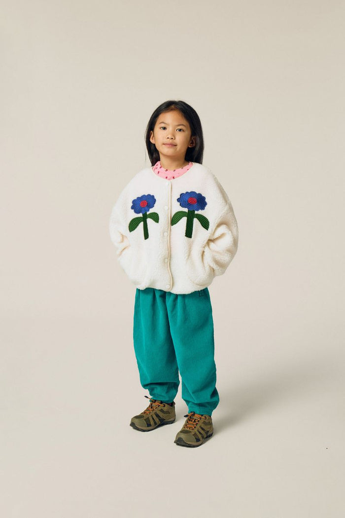 Child wearing green corduroy trousers