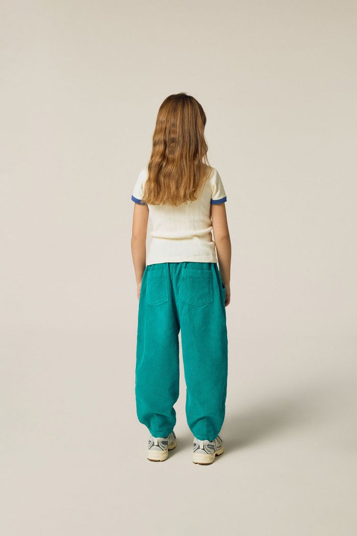 Child wearing green corduroy trousers