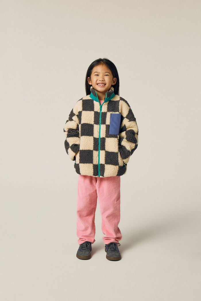 Child wearing pink corduroy pants