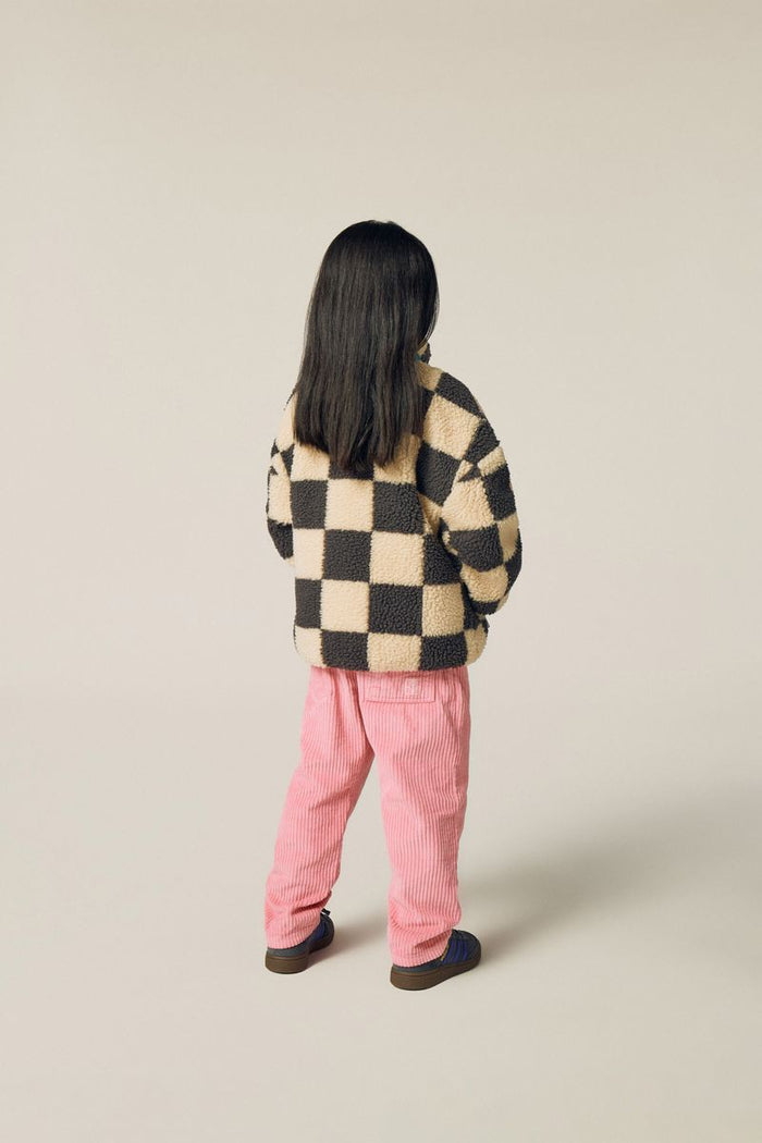 Child wearing pink corduroy pants