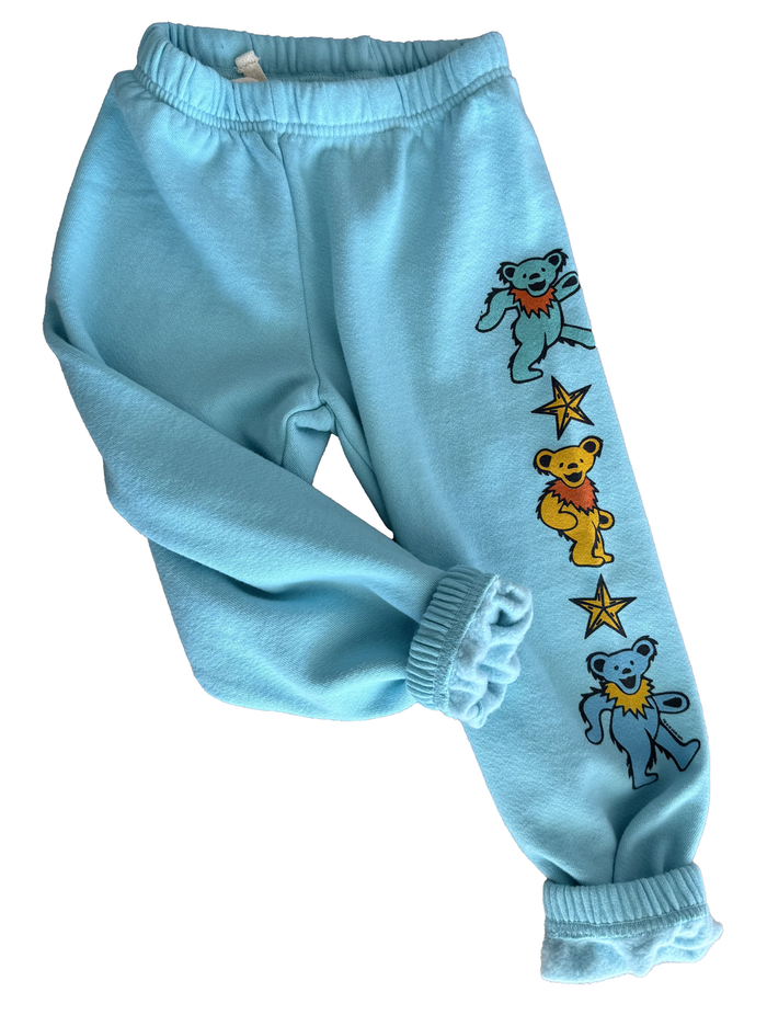 Light blue sweatpants with cartoon bear designs on a white background