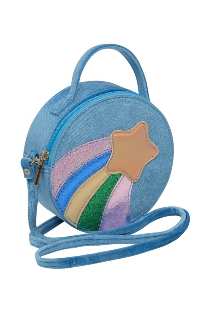 A light blue circular crossbody bag with a rainbow and star design on the front, featuring a top handle and an adjustable shoulder strap, set against a plain white background.