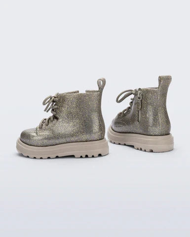 Pair of metallic silver boots on a white background