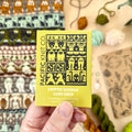 Hand holding the yellow Cryptid Doodle Card Deck by Pacific Knit Co tuckbox