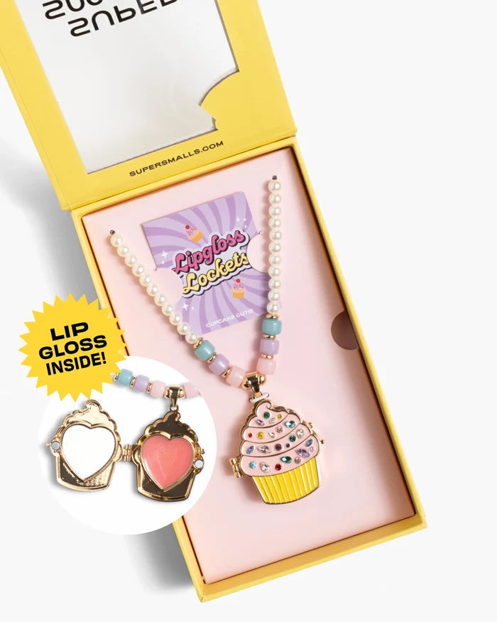 Set of lip gloss, necklace, and compact mirror in a yellow box with 'Super Smalls' branding.