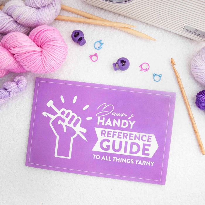 Purple front cover of Dawn's Handy Reference Guide To All Things Yarny showing the full title and yarn ball logo design