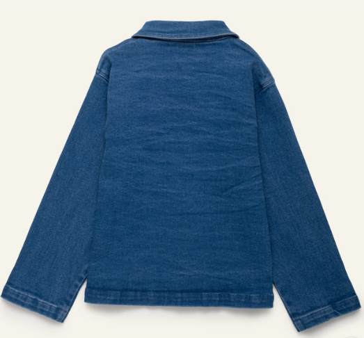 A blue denim jacket shown from the back, featuring a classic collar and long sleeves, laid flat against a light cream background.