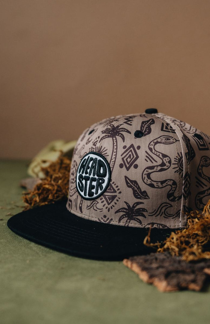 Cap with snake pattern and 'HEADSTER' logo