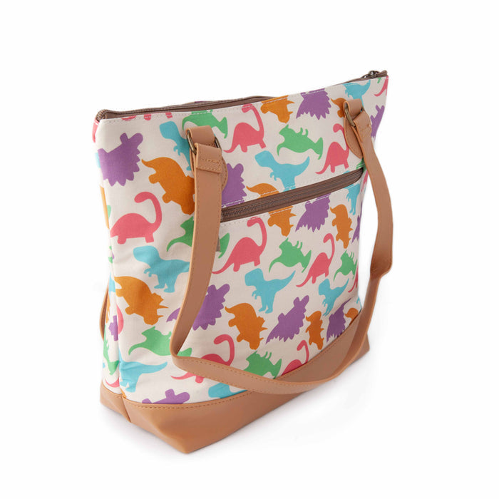Dino Mega Trinity Bag three-quarter view showing the side gusset, zippered exterior pocket, and tan vegan leather shoulder strap with colorful dinosaur silhouette print