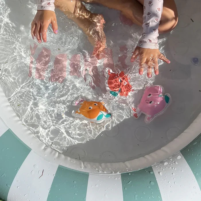 Children playing with colorful pool toys in a kiddie pool.