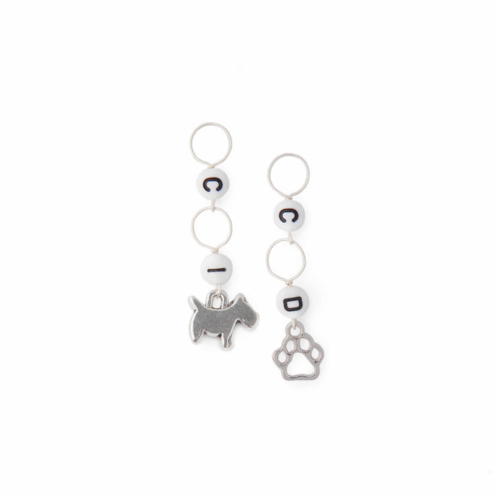 Dog and pawprint crochet counter stitch markers laid flat showing letter beads and silver charms