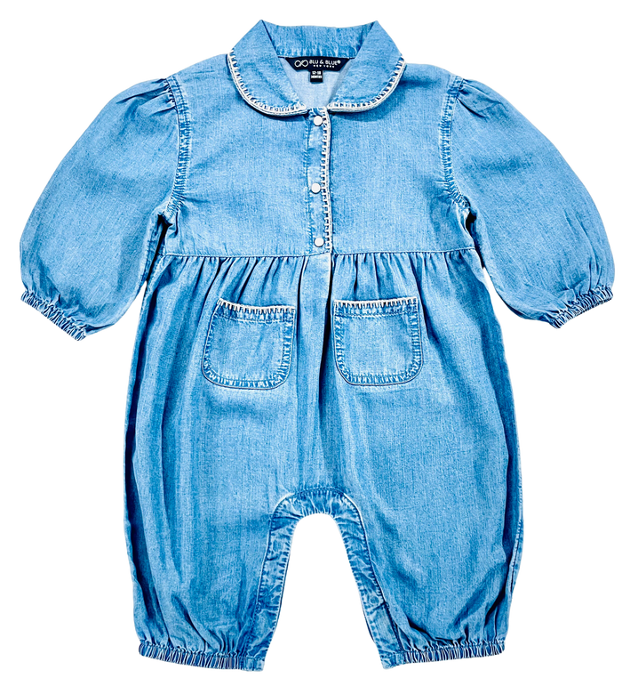 A baby romper in light blue denim with a Peter Pan collar, buttoned front, puffed sleeves, elastic cuffs, and front patch pockets, shown on a plain white background.