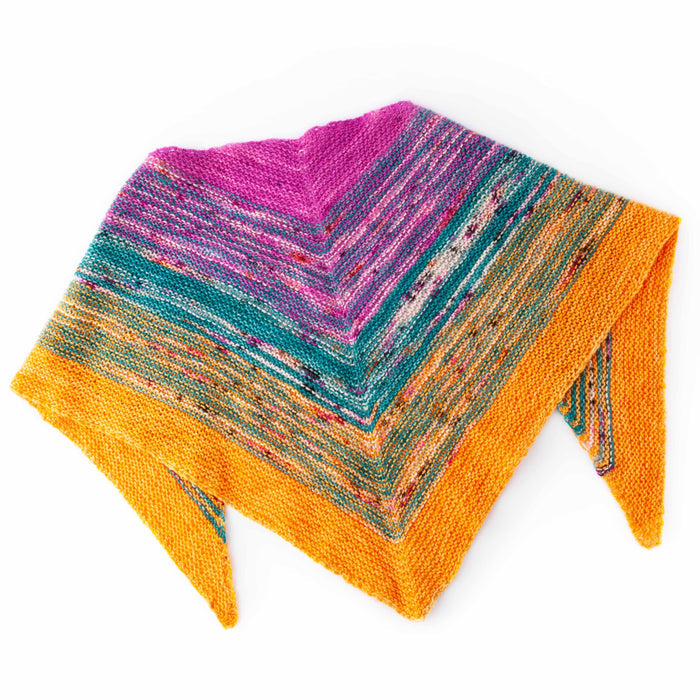 Down By The Sea shawl flat lay showing the folded triangular shape with garter stitch chevron stripes fading from magenta through teal to golden orange
