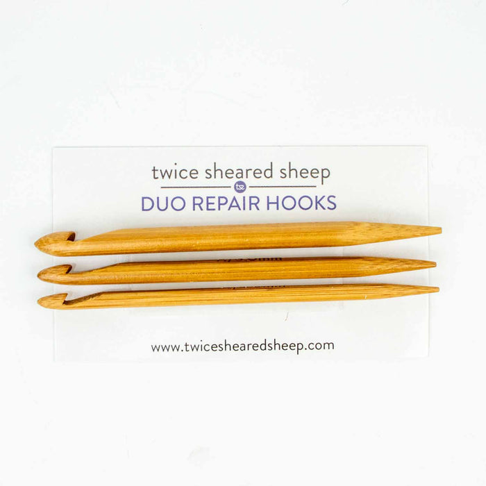 Set of three Duo wooden repair hooks in bamboo on Twice Sheared Sheep branded packaging card showing the double-ended hook and point design