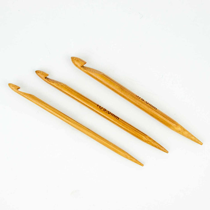 Three Duo wooden repair hooks laid out on a white background showing the graduated sizes with hook on one end and pointed tip on the other