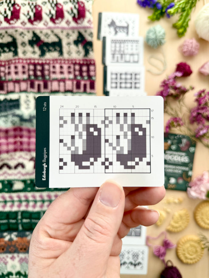 Hand holding an Edinburgh Doodle bagpipes colorwork chart card