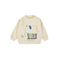 Cream sweatshirt with colorful sketch of an elephant wearing a hat, shoes, and multi color legs on white background. Text reads "The Art of Being an Elephant".