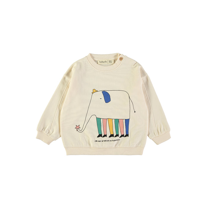Cream sweatshirt with colorful sketch of an elephant wearing a hat, shoes, and multi color legs on white background. Text reads "The Art of Being an Elephant".