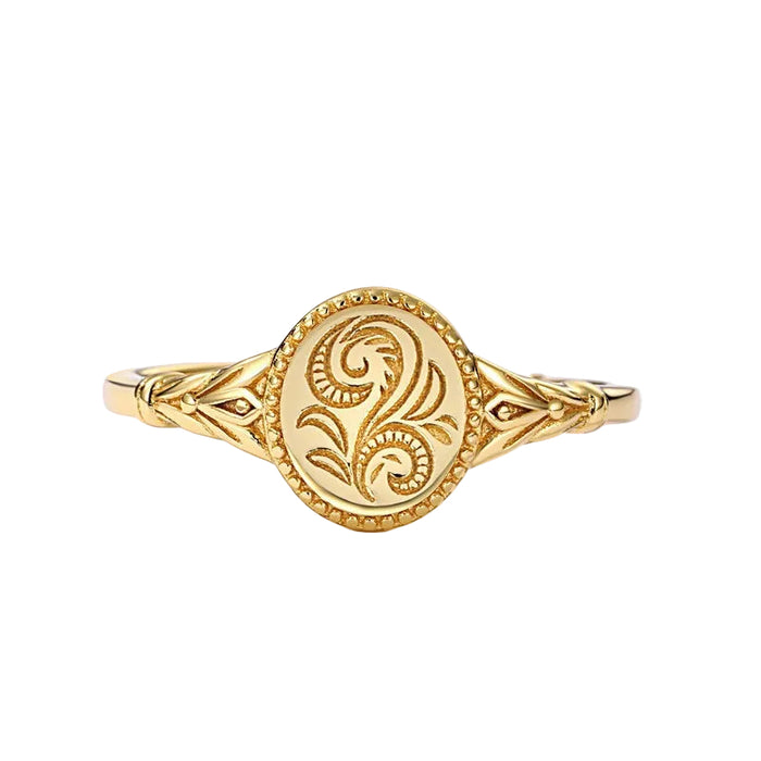 Top view of a gold oval signet ring featuring an embossed floral vine design on a white background.