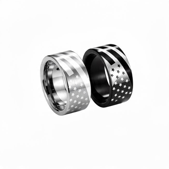 Two American flag stainless steel rings on pure white background, one brushed silver with engraved stars and stripes and one black band with white flag design
