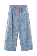 Floral-patterned pants with a pink drawstring on a white background