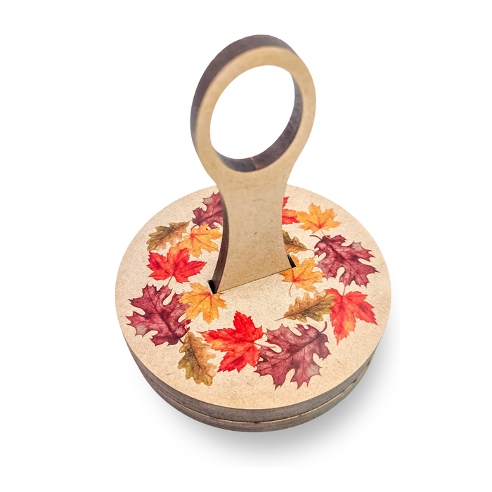 Fall Leaves Yarn To Go Carousel assembled, wooden base and lid printed with a watercolor autumn leaf wreath and an upright yarn guide