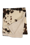 Blanket with brown and white cow print pattern on a white background