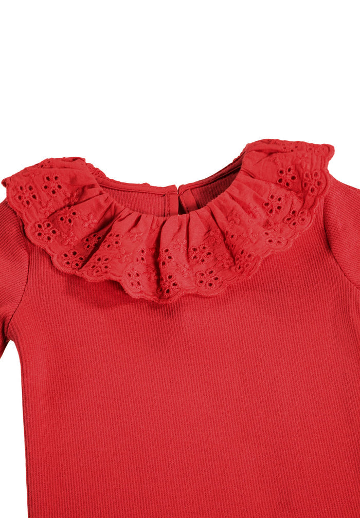 Red top with a ruffled collar on a white background