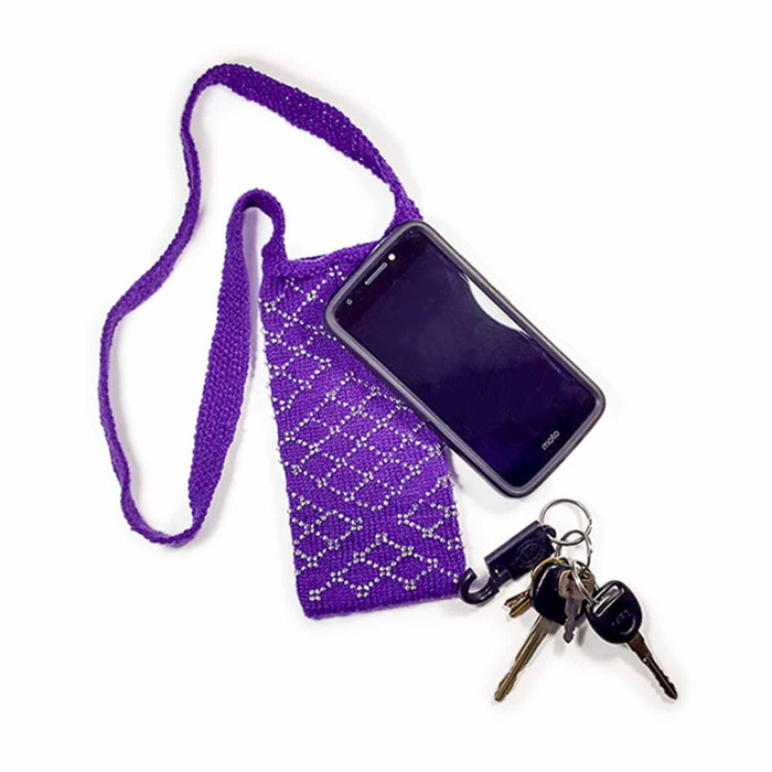 Purple beaded knitted Filigree Essentials crossbody bag with phone and keys on white background