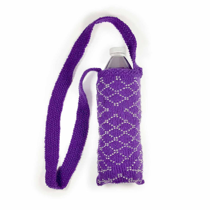 Purple beaded knitted Filigree Essentials bag holding a water bottle showing shoulder strap