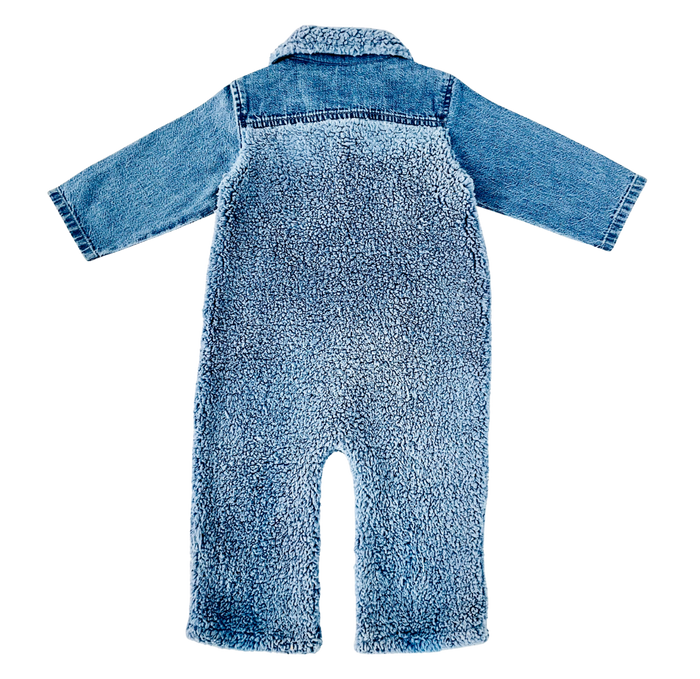 A baby's one-piece jumpsuit shown from the back, featuring a soft, plush fleece body with a light blue denim collar and cuffs, set against a plain white background.