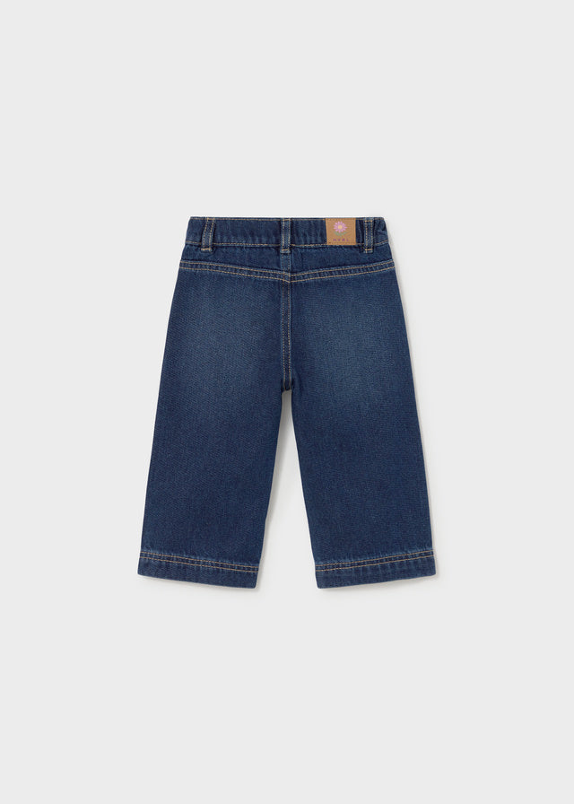 Pair of blue jeans on a light gray background