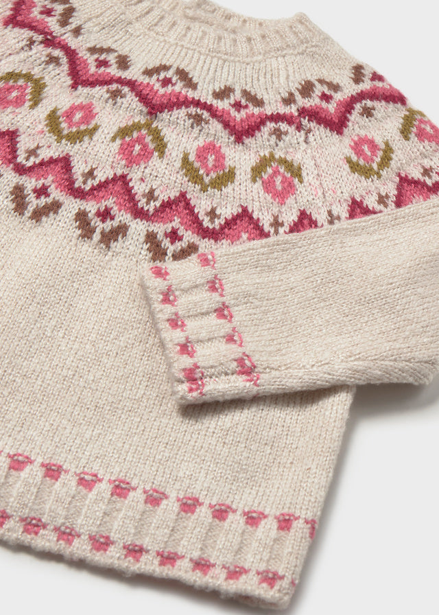 Knitted fabric with a pattern of pink flowers and green leaves on a white background