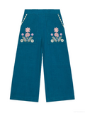 A pair of wide-leg teal corduroy pants featuring embroidered floral patterns on the back pockets with decorative braided trim along the side seams, shown against a plain white background.