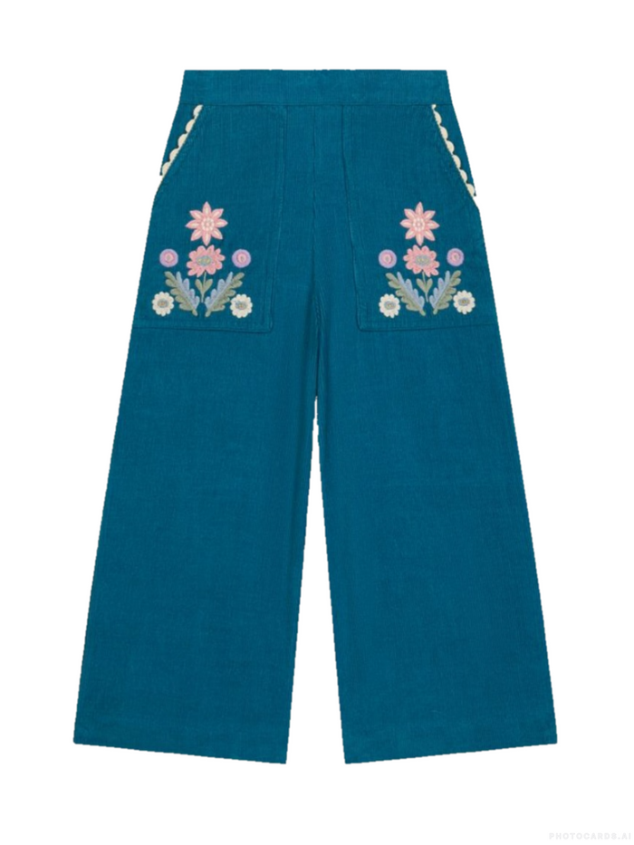 A pair of wide-leg teal corduroy pants featuring embroidered floral patterns on the back pockets with decorative braided trim along the side seams, shown against a plain white background.